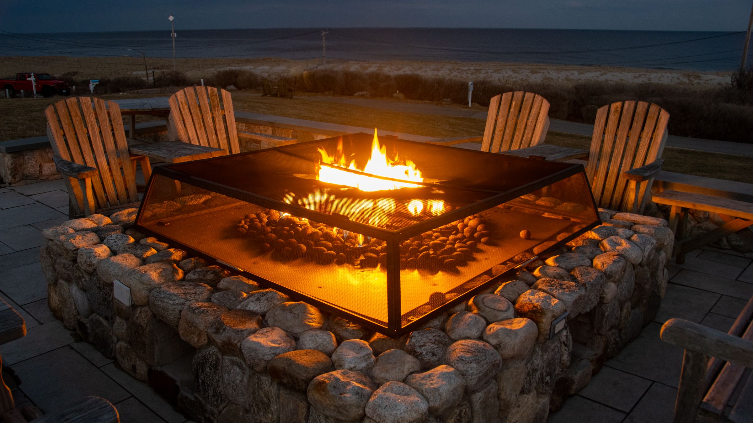 A beachside fire pit glowing at twilight near Sea Esta in Dillon Beach